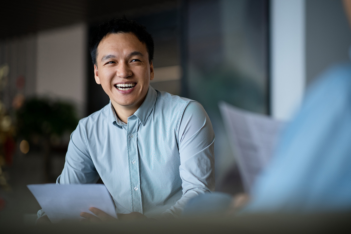 Master of legal studies student smiling at table